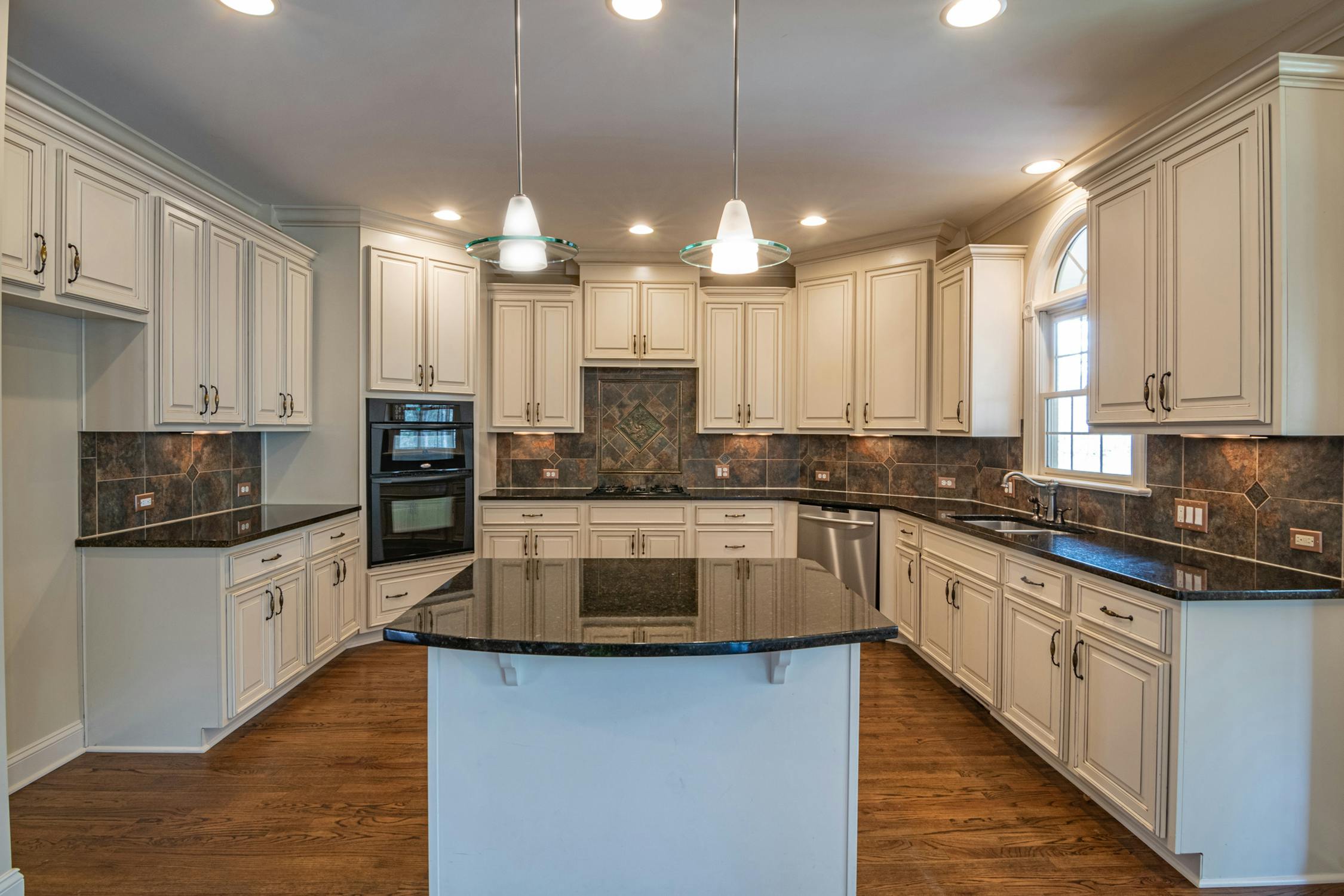 High-end inset cabinet kitchen with painted white cabinetry and quartz countertops