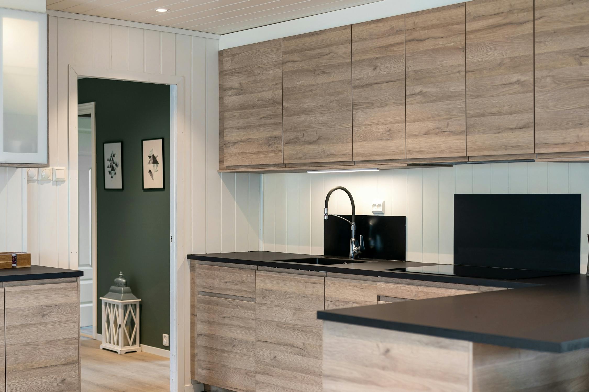 Modern flat panel wood kitchen cabinets with black hardware in Ammon, Idaho